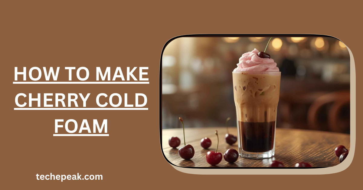 Cherry cold foam being poured over iced coffee in a clear glass.